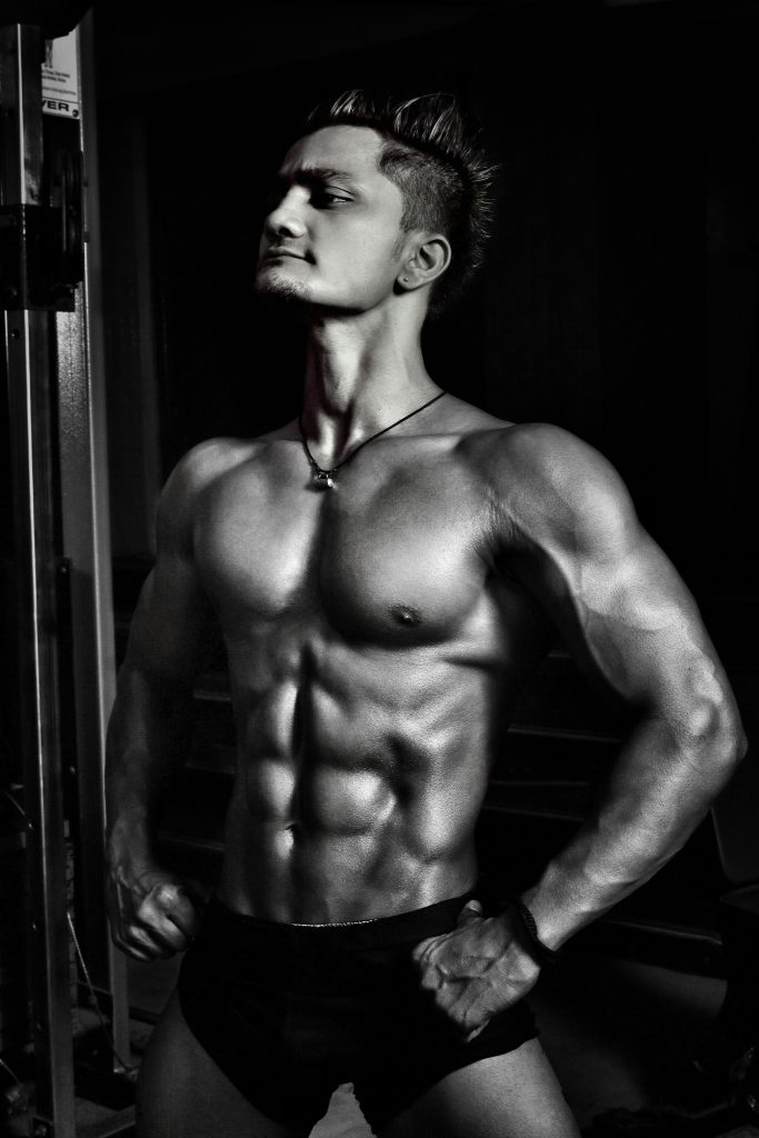 pexels-photo-896059-896059 Dynamic black and white image of a muscular male bodybuilder striking a powerful pose.
